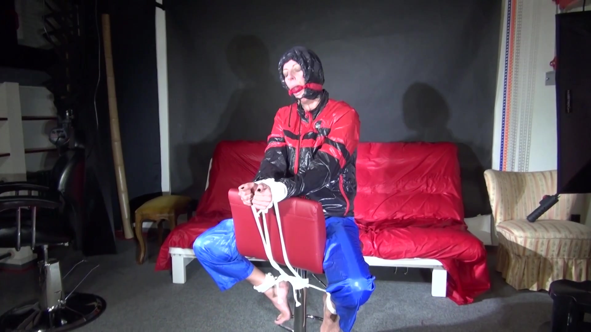 Sexy Pia Being Tied And Gagged On A Chair Wearing Sexy Shiny Nylon Rainwear (Video)