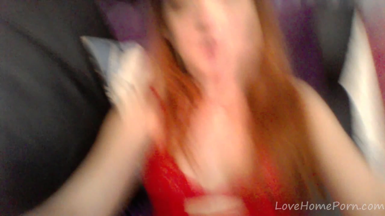 Redhead in a red dress rubs her pussy