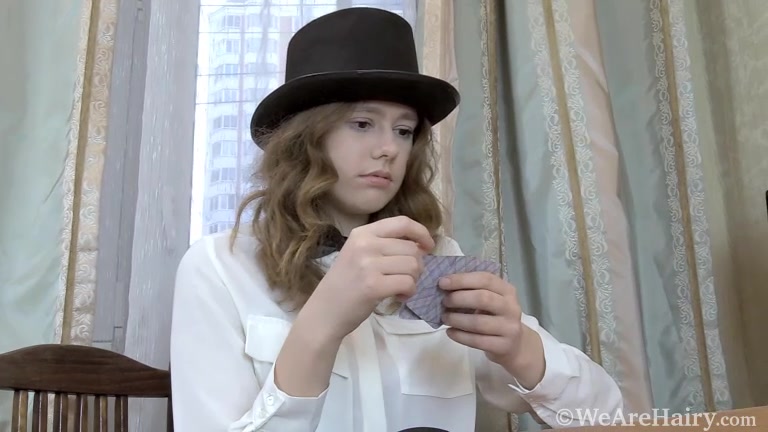 Larisa performs card tricks with her sexy top hat