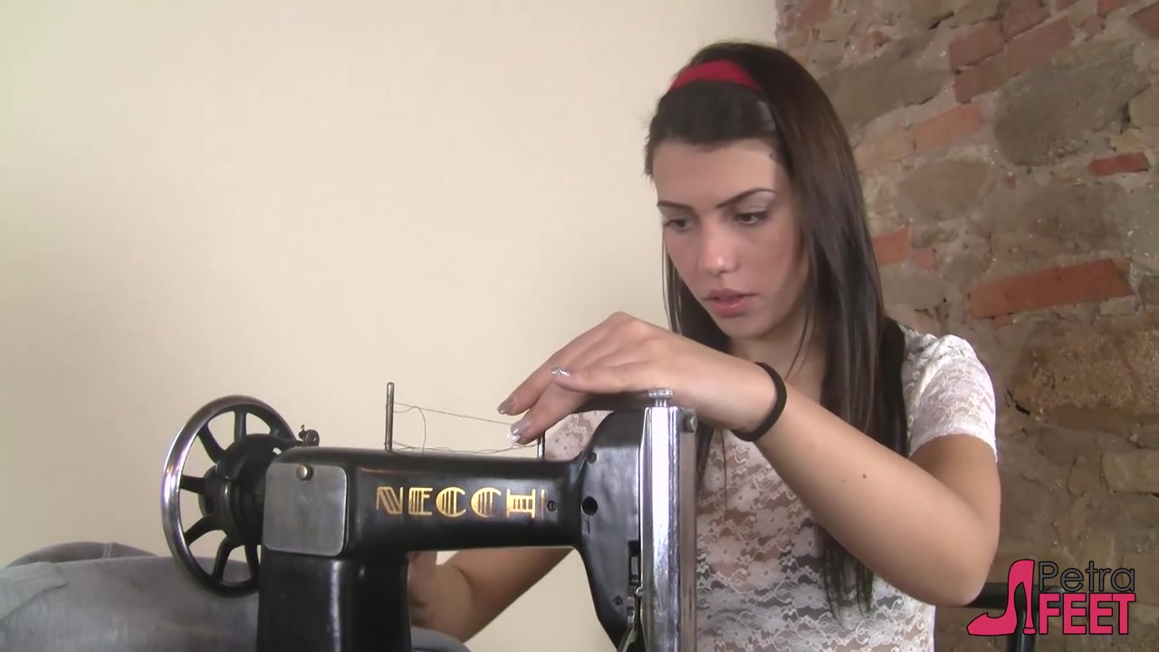 Leggy Petra pumping a vintage sewing machine pedal with her pantyhosed feet