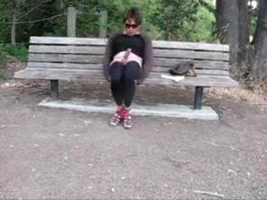Lovely crossdresser jerks it on a park bench