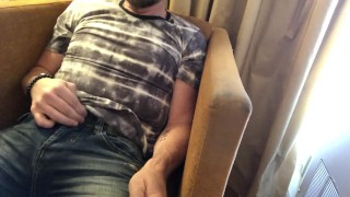 Pulling out bulging cock from jeans and stroking