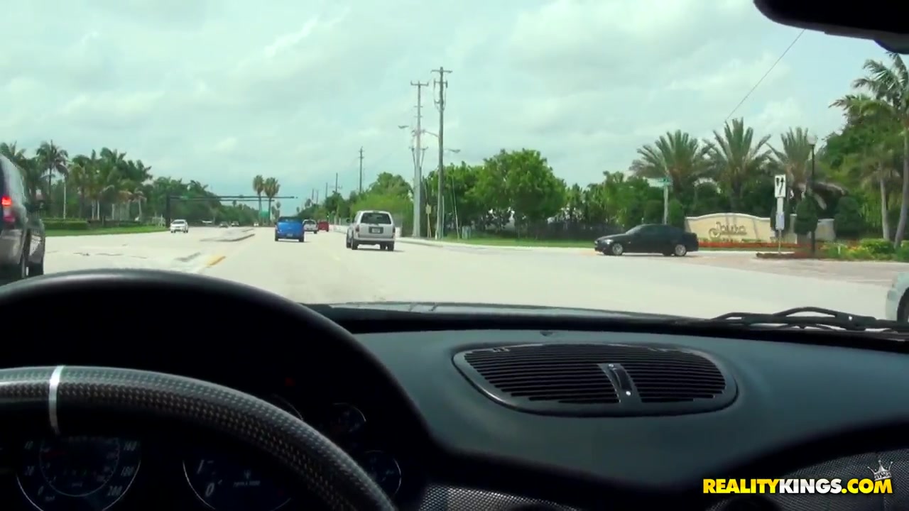 Caprice sucks on a dong while driving