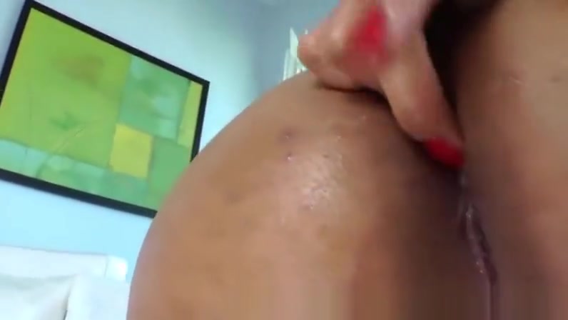 A busty black shemale makes her pierced dick erect