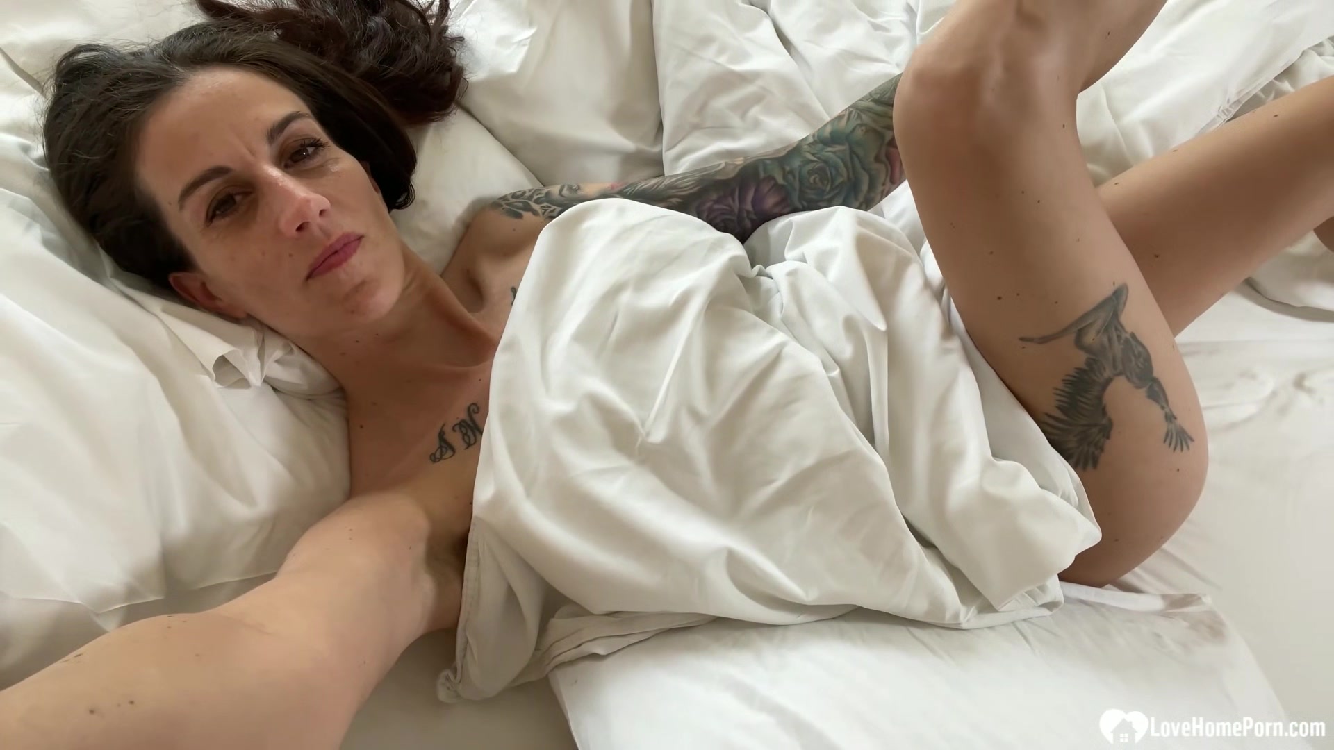 Cute tattooed girl playing with her slit