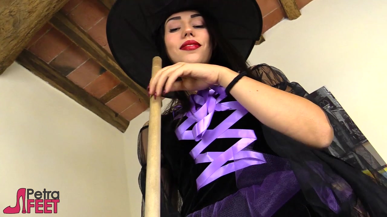 Stunning Petra dressed in a cosplay witch costume with black stockings.