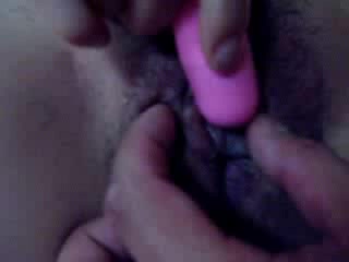 Lustful Asian wench stimulating her cunt with vibrator