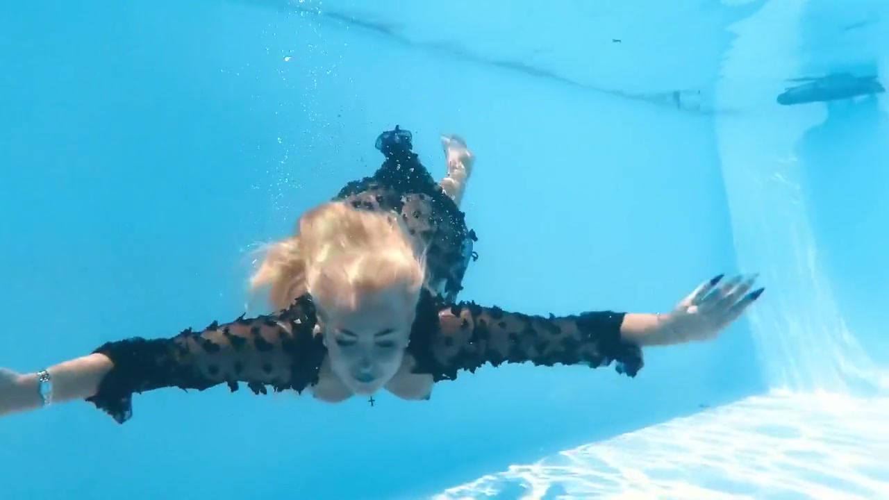 A Woman Floats In A Butterfly-adorned Mesh Dress
