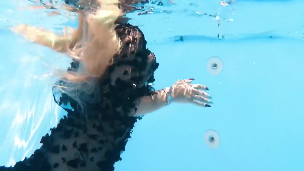 A Woman Floats In A Butterfly-adorned Mesh Dress