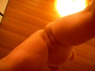 Down camera view of a masturbating busty woman