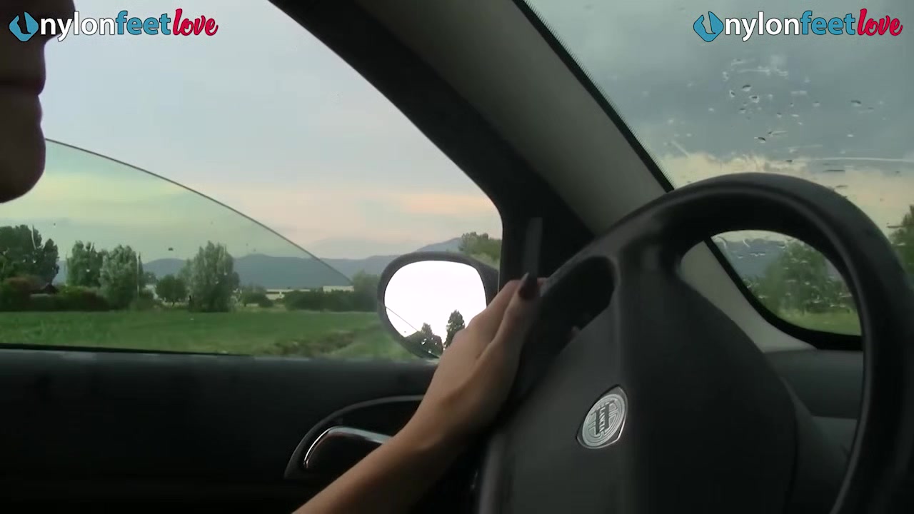 Redhead shows off panties and stockings in car and drives