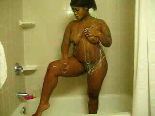 Ebony bitch with curves washes her brown twat in the shower
