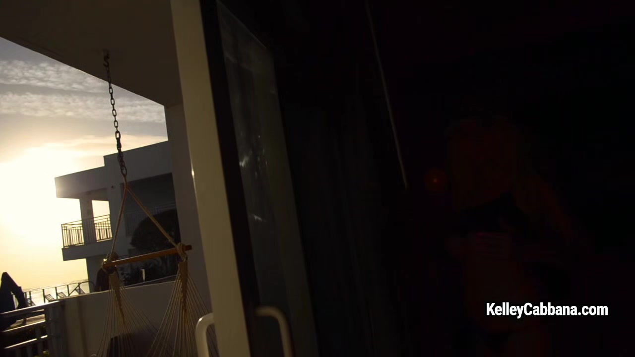 Busty lady Kelley Cabbana masturbates against the opened window