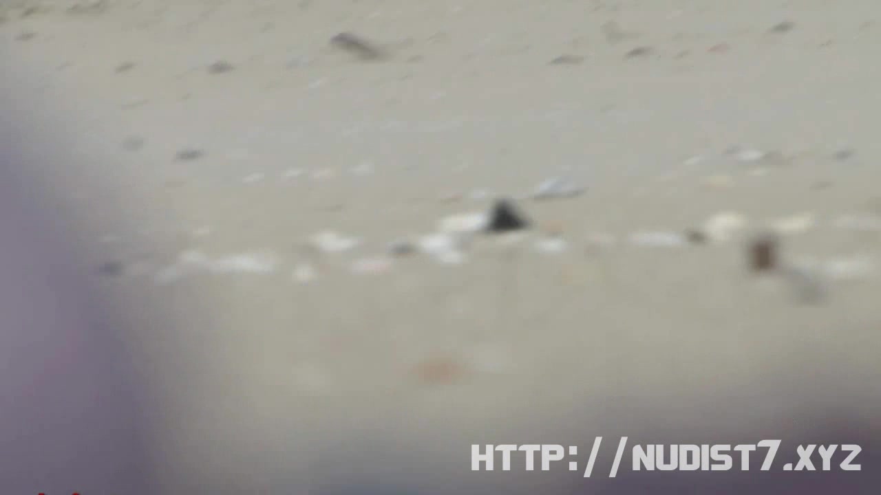 Chick on a nudist beach tanning and bending a nudist beach