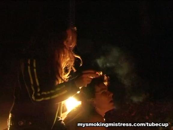 Smoking Mistress Sits on Slave