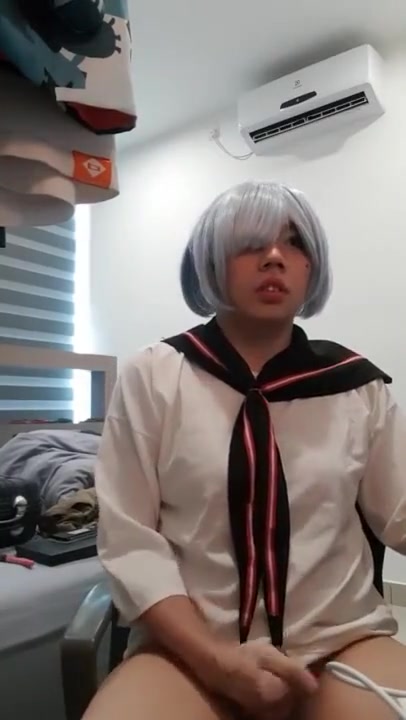 A crossdressing sissy boy masturbating while watching porn
