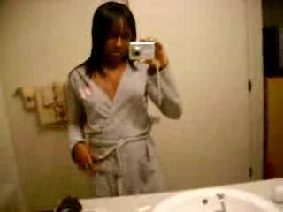 Ebony shoots her fine pussy in front of the mirror
