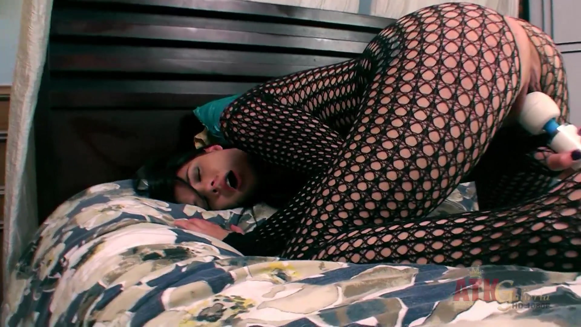 Izzy Champayne wearing fishnet bodystockings rubs pussy with hitachi