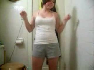 Small-titted babe dances and strips to the music