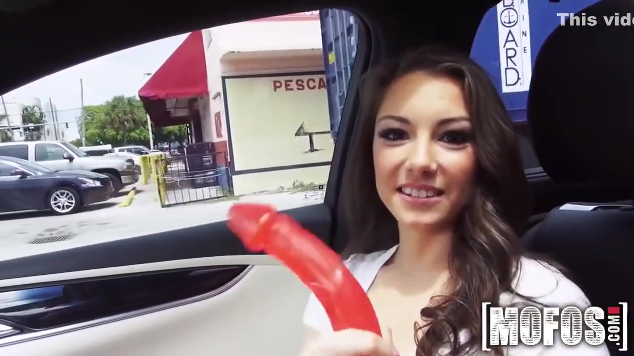 Hot Brunette In A Car With Red Dildo