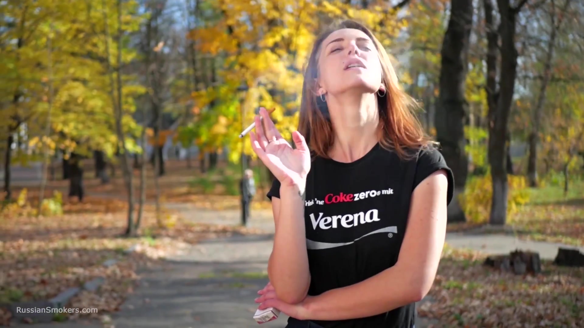 Sasha Is Smoking Two Cigarettes One By One In The Autumn Park