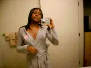 Ebony shoots her fine pussy in front of the mirror