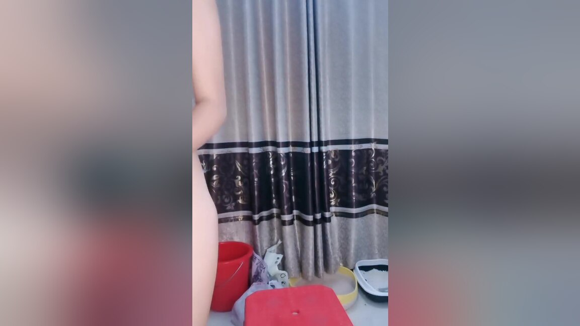 A camera in the restroom catches an Asian woman urinating.