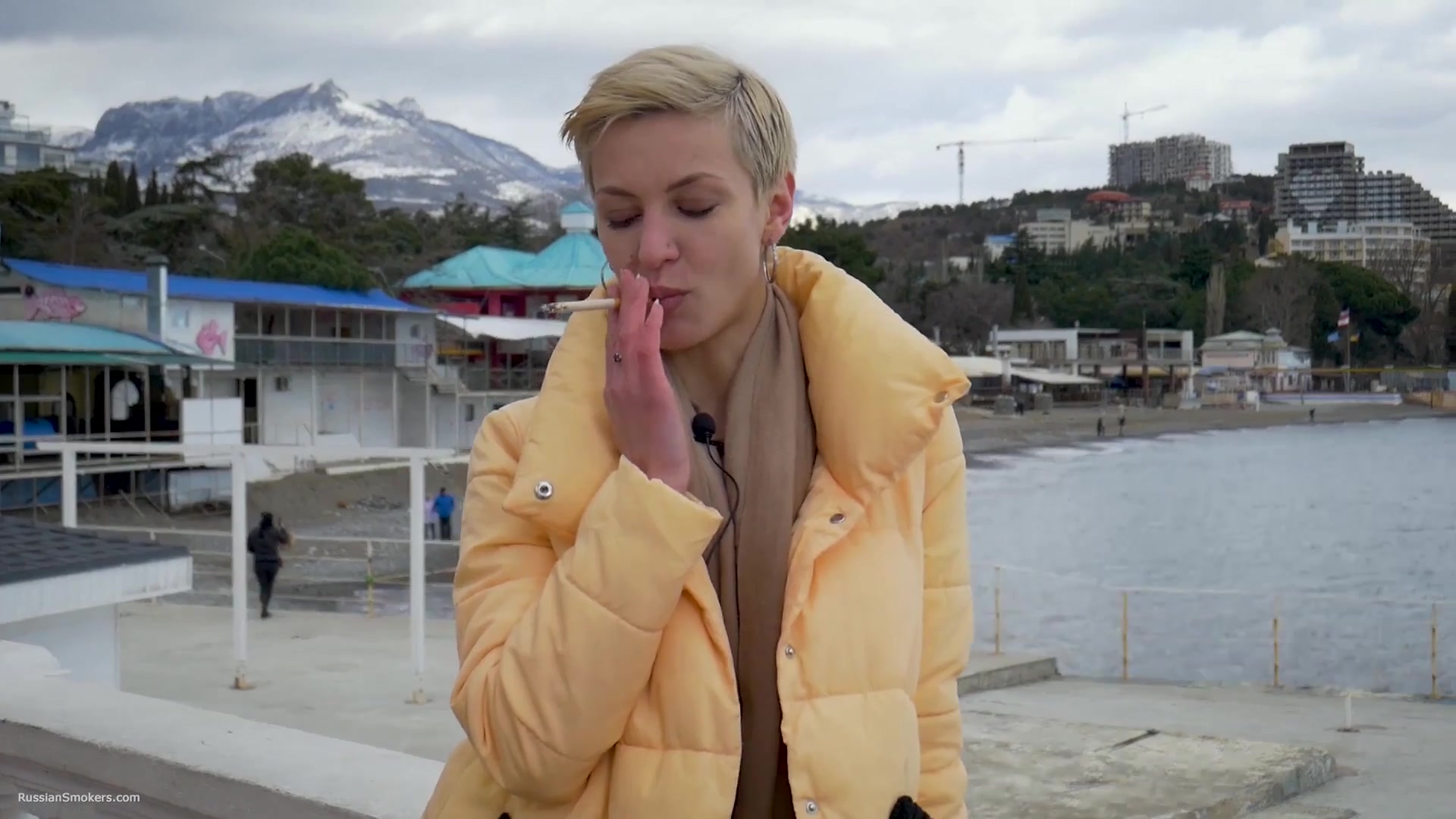 Short Cut Hair Blonde Girl Is Smoking Two Cork Cigarettes