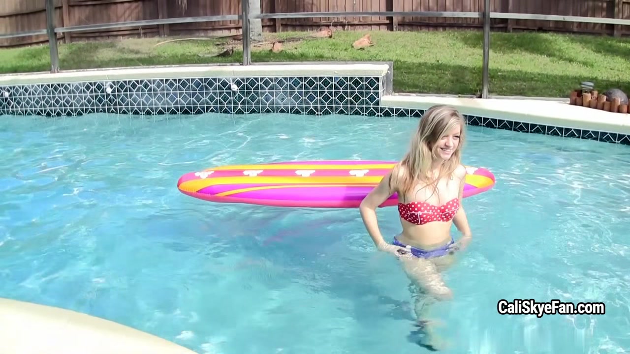 Joyful well shaped Cali Skye is dresses off in the pool