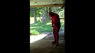 red zentai jerking off at garage door