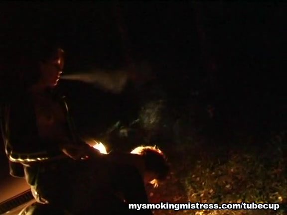 Smoking Mistress Sits on Slave