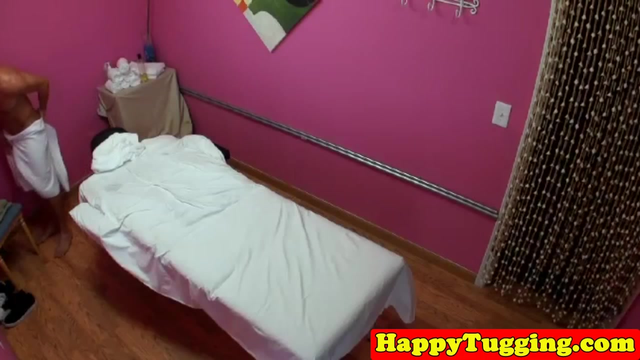 Asian massage therapist jerking her client