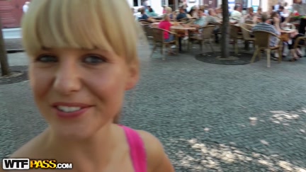 Hawt beauty shows melons in the midst of a lively square