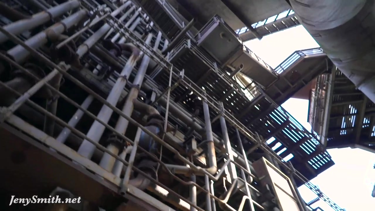 Jeny Smith is walking naked through an abandoned factory.