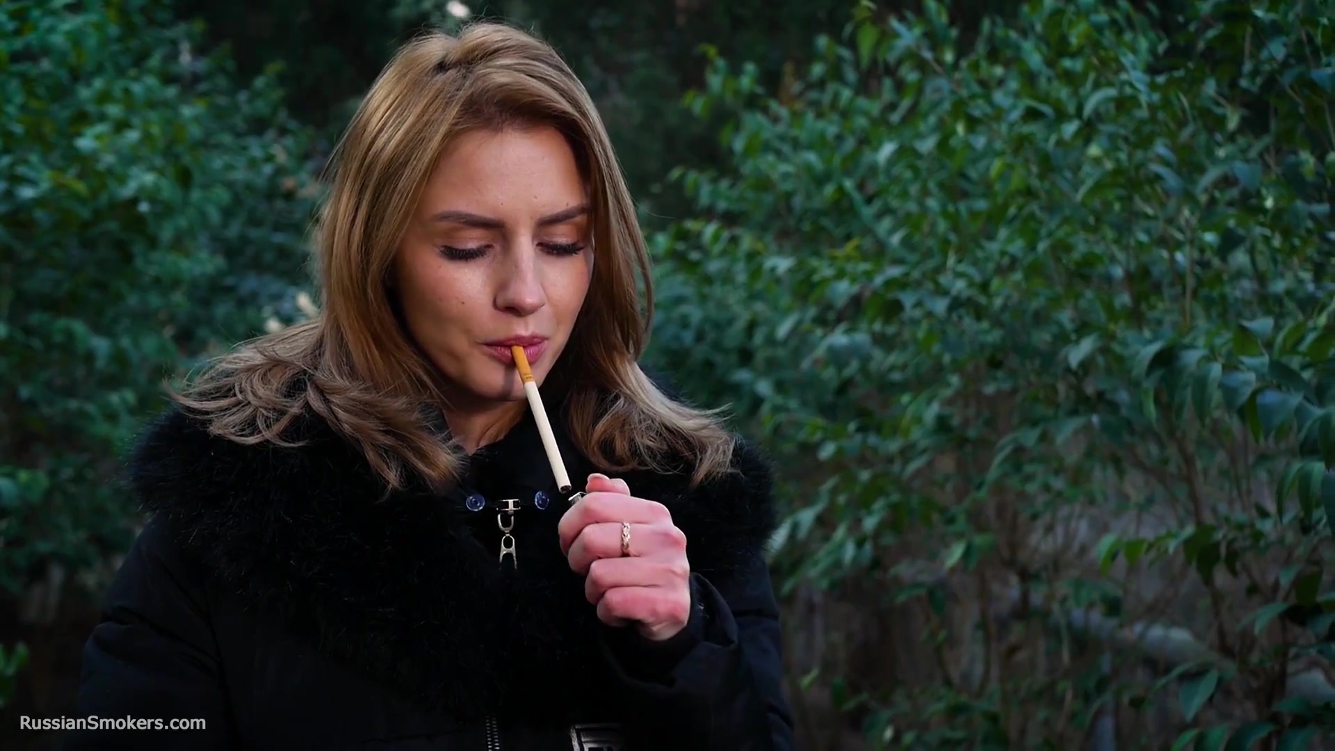 Absolutely Stunning Lady Is Smoking Two Long Cigarettes In The Park