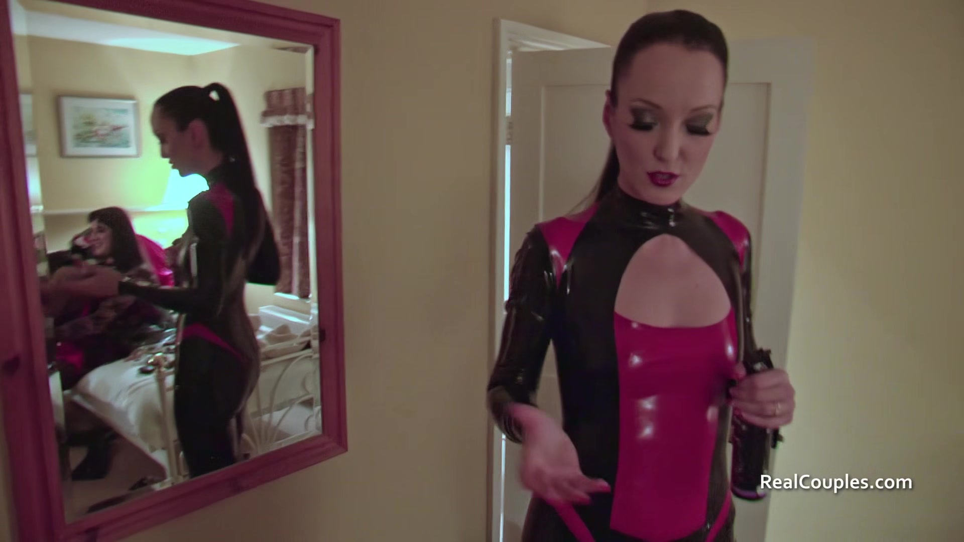 Cross dressing husband with PVC clad wife