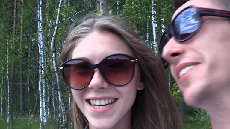 Youthful pair walking in the woods drilled