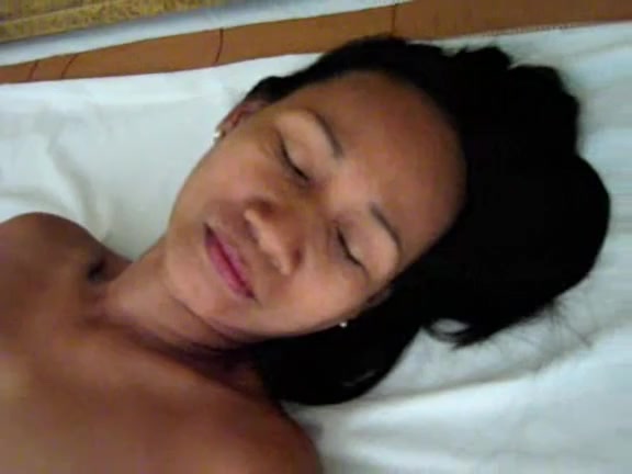 Slim Asian woman laid on a white pillow and rubbed her twat