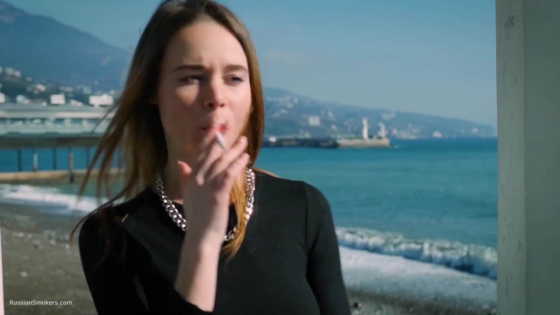 Slim Chick Basks In The Sun With A Cigarette In Her Hand