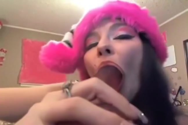Asian girl sucking her fake cock and thinking of a real one