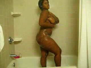 Ebony bitch with curves washes her brown twat in the shower