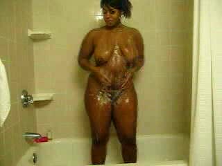 Ebony bitch with curves washes her brown twat in the shower