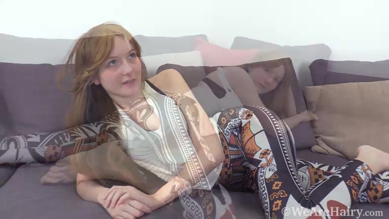 Emma Valentine strips naked on her grey sofa - WeAreHairy