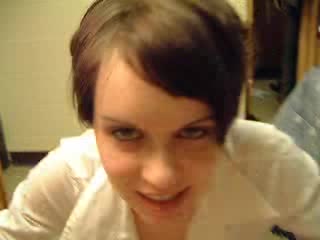 Short-haired cutie flashes ass and takes a cock in her mouth
