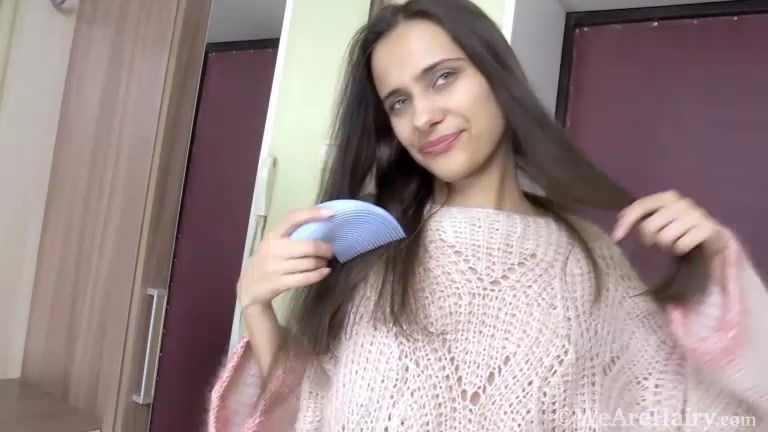 Klara models her sweater in her hallway today