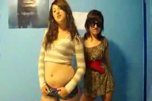 Stunning young brunettes dancing to music and stripping