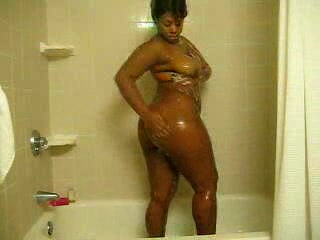Ebony bitch with curves washes her brown twat in the shower