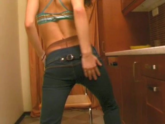 Beauty in taut jeans and brassiere moves teasingly