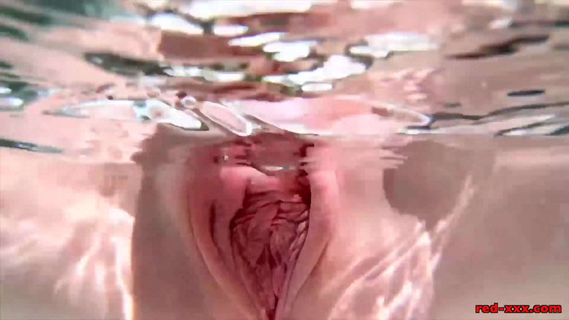 Red XXX masturbates poolside with an ice dildo