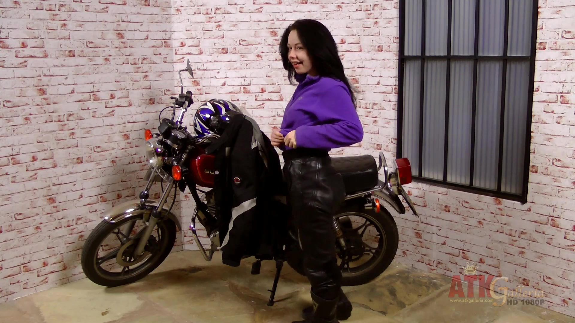 Lizzie does an extensive strip-tease by her big motorcycle